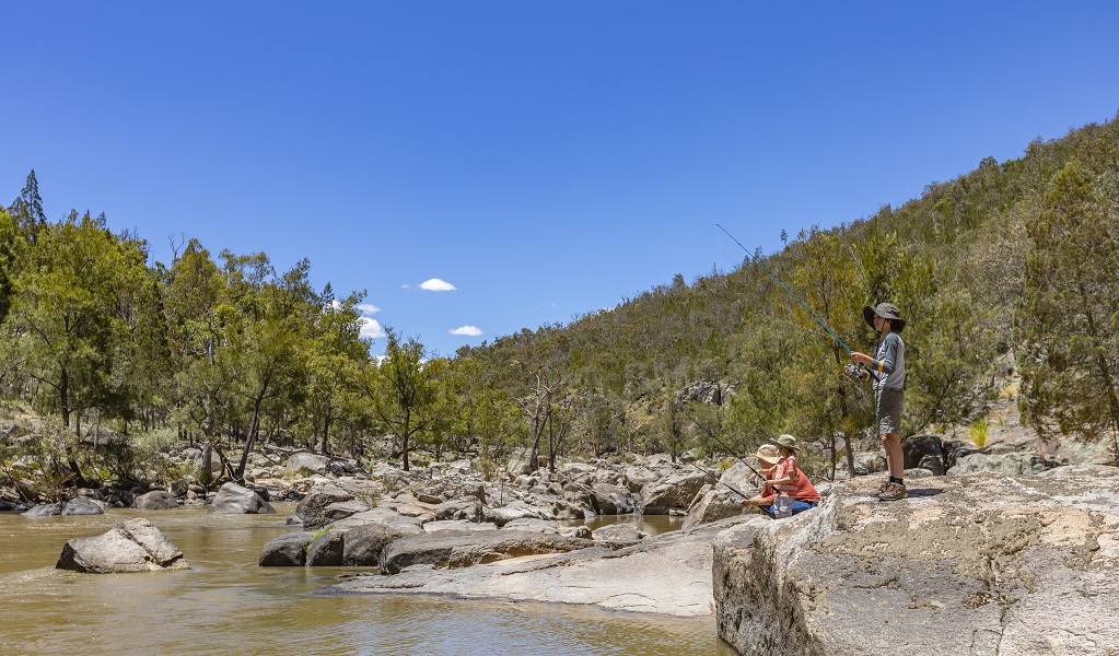 A family enjoy fishing at the edge of Naomi River, Warrabah National Park. Photo: Joshua Smith &copy; DPE