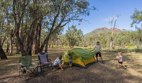 A family setting up their tent at Camp Blackman. Credit: John Spencer &copy; DCCEEW