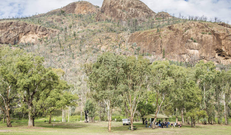 A group enjoying a picnic beside their car at Canyon picnic area, Warrumbungle National Park. Photo: Simone Cottrell &copy; shared OEH and photographer