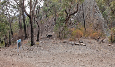 Camping area at Danu camp, set in rugged landscape of bushes, trees and rock formations. Photo: Blake McCarthy &copy; DPIE