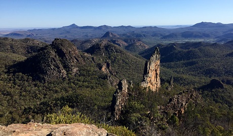 View past rock ledge to volcanic spires and mountains stretching into the distance. Photo: May Fleming &copy; May Fleming