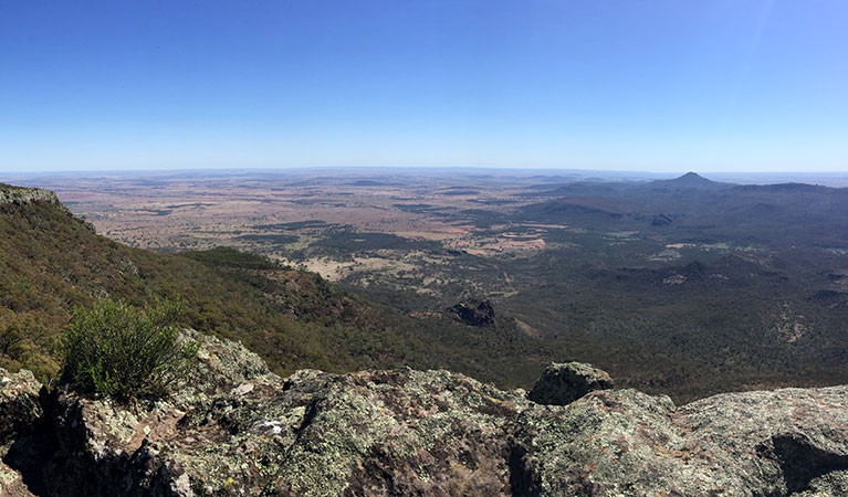 Wide-open view past a rocky ledge to distant mountains peaks and wide open plains. Photo: May Fleming &copy; May Fleming