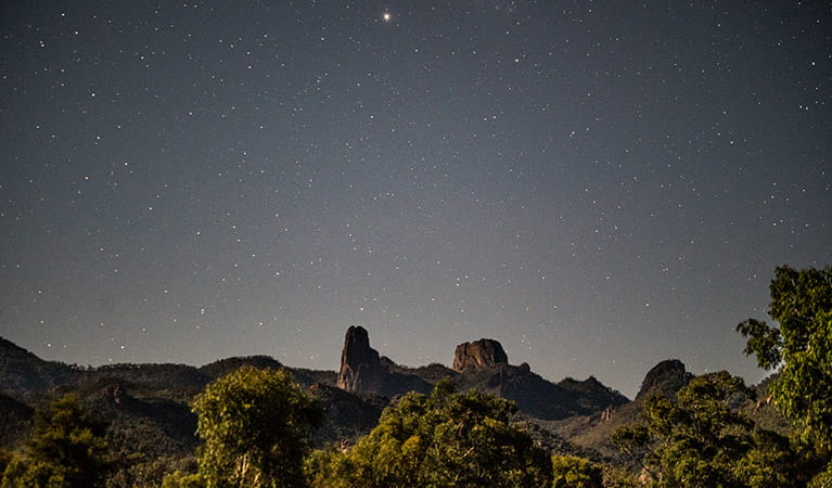 A starry night view across the Grand High Tops rock formation in Warrumbungle National Park. Photo: Robert Mulally/OEH