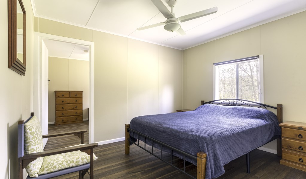 A bedroom with double bed at Four Bull Hut in Washpool National Park. Photo &copy; DPE