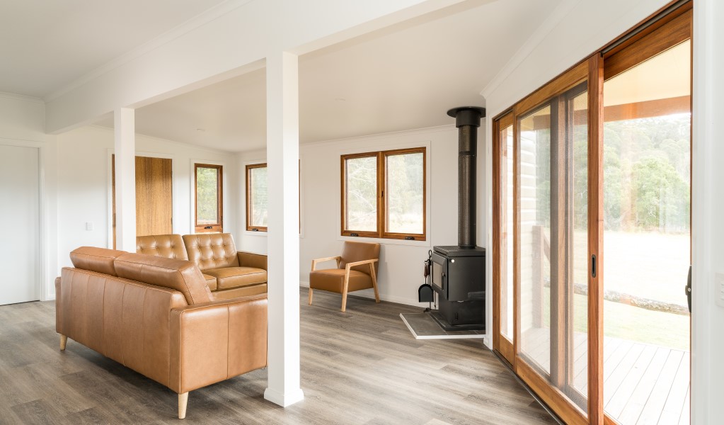 The living room with fireplace at Mooraback Cabin in Werrikimbe National Park. Photo: David Waugh &copy; DPE