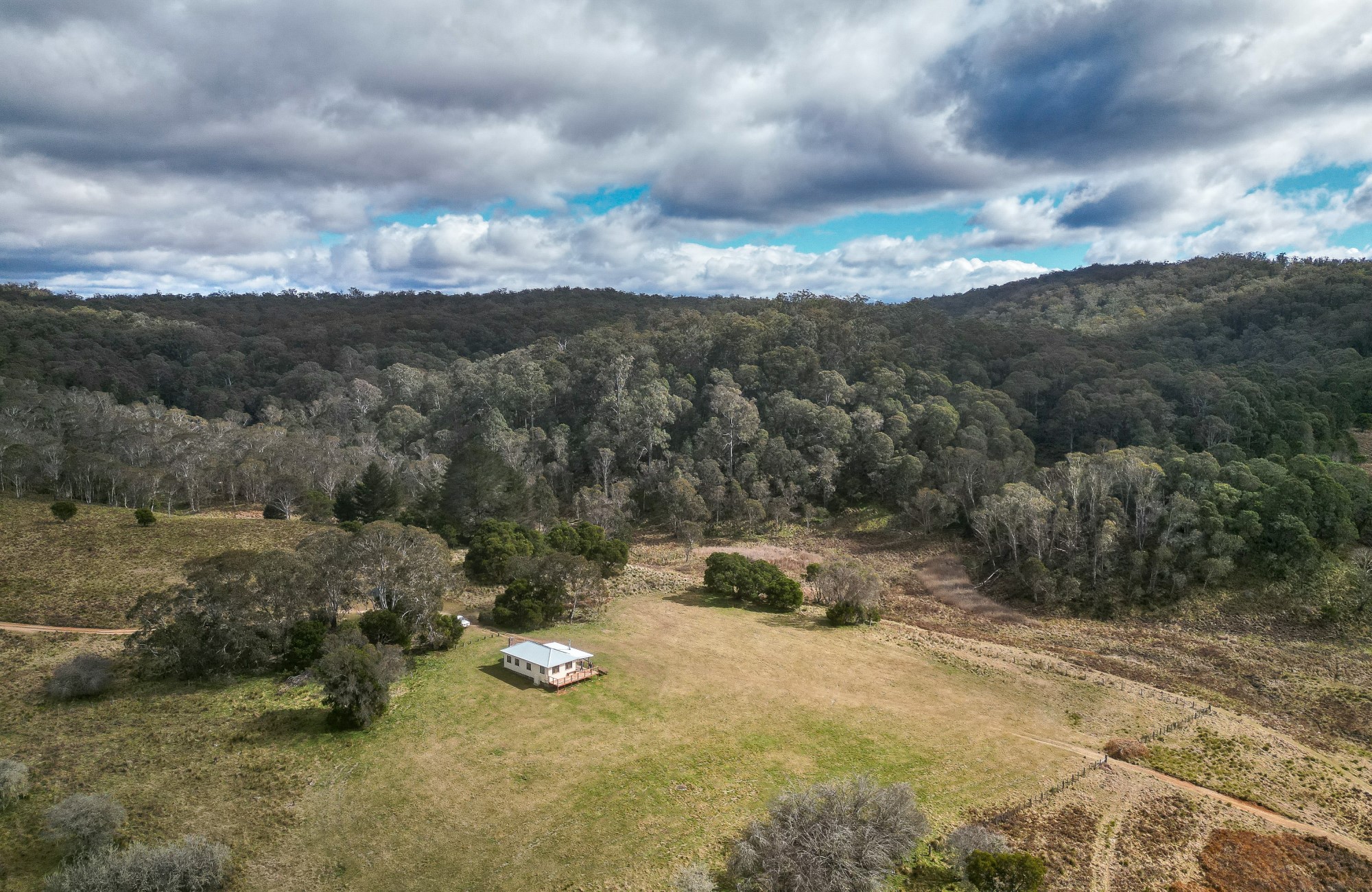 An aerial shot of Mooraback Cabin surrounded by World Heritage-listed Gondwana rainforest in Werrikimbe National Park. Photo; David Waugh &copy; DPE