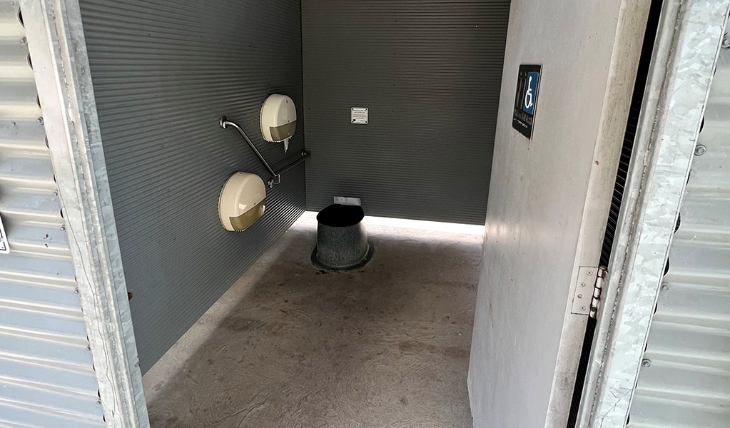 Interior view of the non-flush toilet with handrail at Coorongooba campground. Credit: &copy; DCCEEW