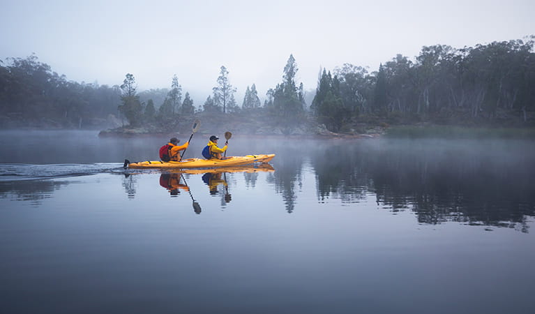 Morning kayakers in mist at Dunns Swamp-Gunguddy, Wollemi National Park. Photo: Daniel Tran/OEH.