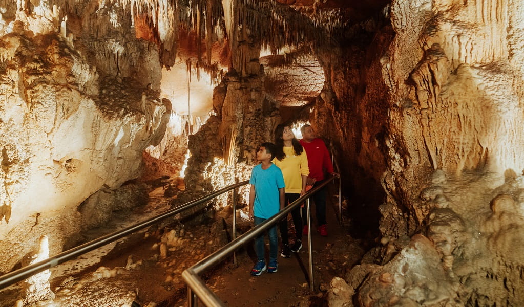 Visitors walk along a path surrounded by beautiful cave formations in Mulwaree Cave. Credit: Remy Brand/DPE &copy; Remy Brand