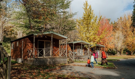 A family group arrive, walking up to Wombeyan Caves cabins, at the start of their stay at Wombeyan Karst Conservation Reserve. Credit: Remy Brand/DPE &copy; Remy Brand