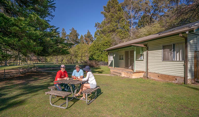 Family picnic at Post Office Cottage at Wombeyan Caves. Photo: OEH/John Spencer