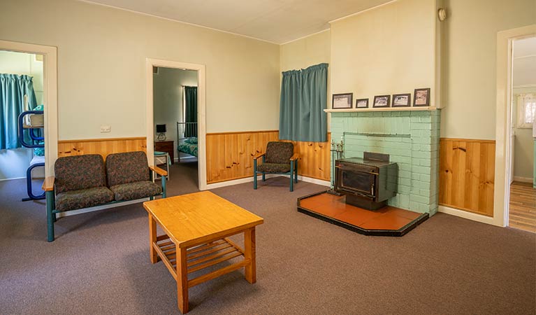 Lounge room at Post Office Cottage, including a wood fire. Photo: OEH/John Spencer