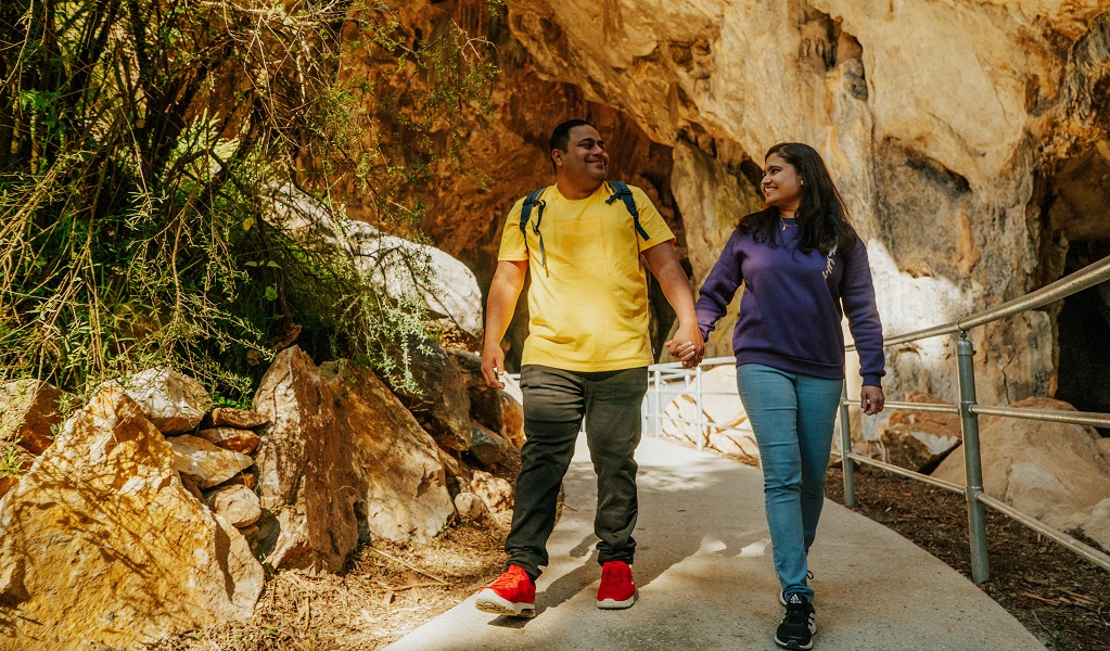 A man and a woman, holding hands, walk along the  Victoria Arch walking track. Credit: Remy Brand/DPE &copy; Remy Brand