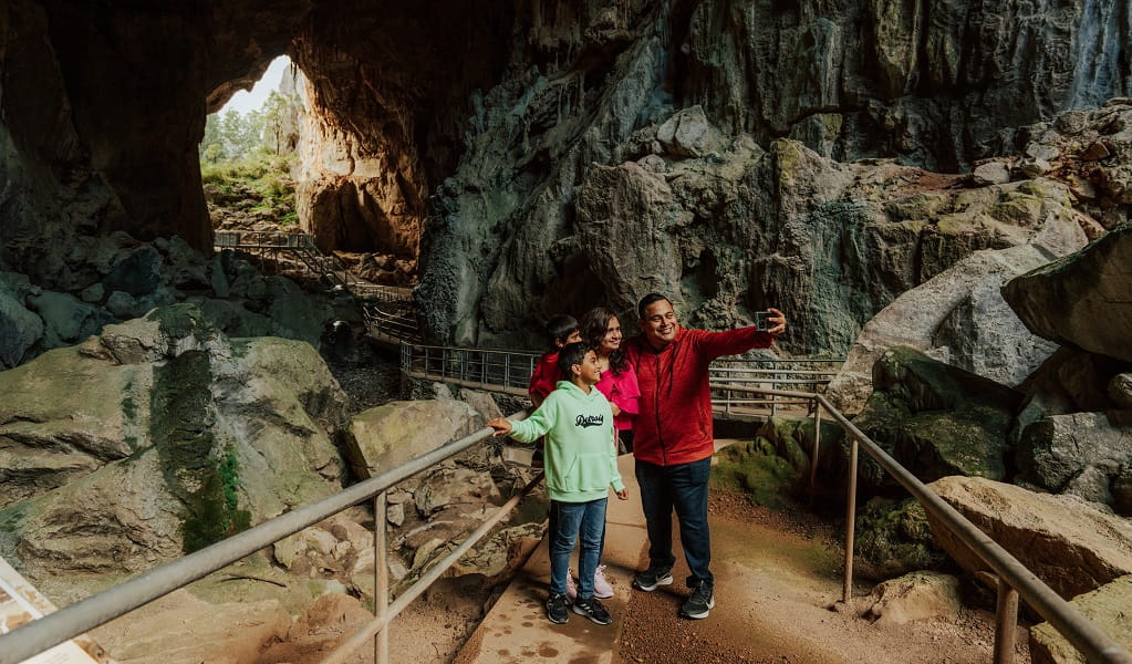 A family take a group selfie inside Victoria Arch, the last chamber in the majestic Fig Tree Cave. Credit: Remy Brand/DPE &copy; Remy Brand