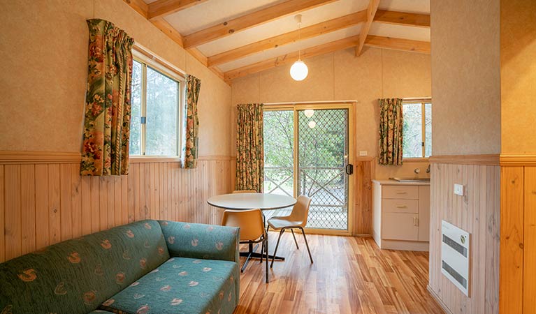 Combined lounge and dining room in a cabin at Wombeyan Caves. Photo: OEH/John Spencer