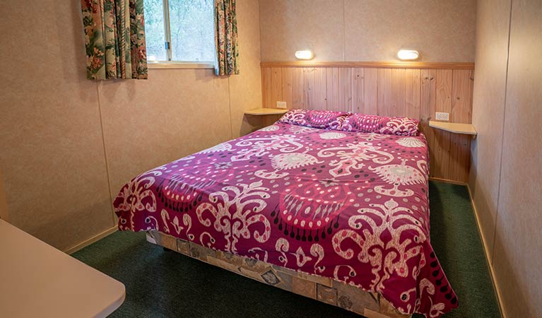 Bedroom with double bed in Wombeyan Caves cabins. Photo: OEH/John Spencer