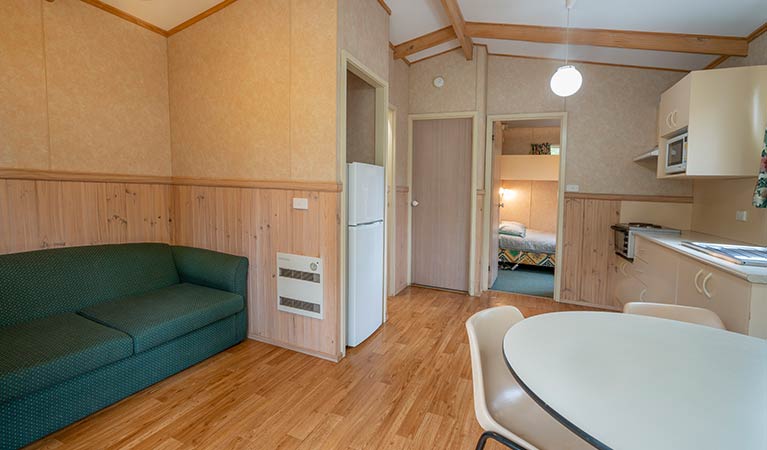 Interior of one of the Wombeyan Caves cabins with combined lounge, kitchen and dining space. Photo: OEH/John Spencer