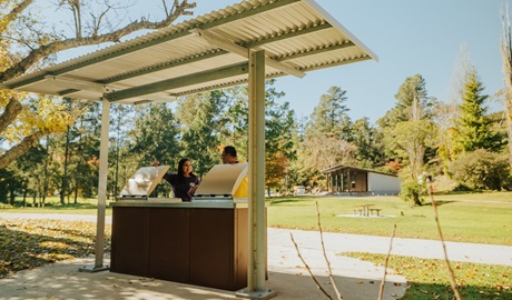 A couple chat while preparing lunch at the barbecue in Wombeyan picnic area. Credit: Remy Brand/DPE &copy; Remy Brand