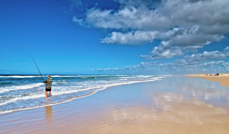 A man fishing on the beach in Worimi National Park. Photo: John Spencer &copy; DPIE