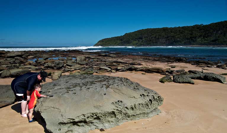 People at the rocks near Bateau Bay picnic area. Photo: John Spencer