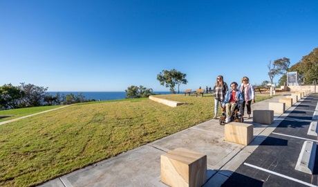 A group of friends on the concrete path at Crackneck Point lookout in Wyrrabalong National Park. Photo: John Spencer © DPE