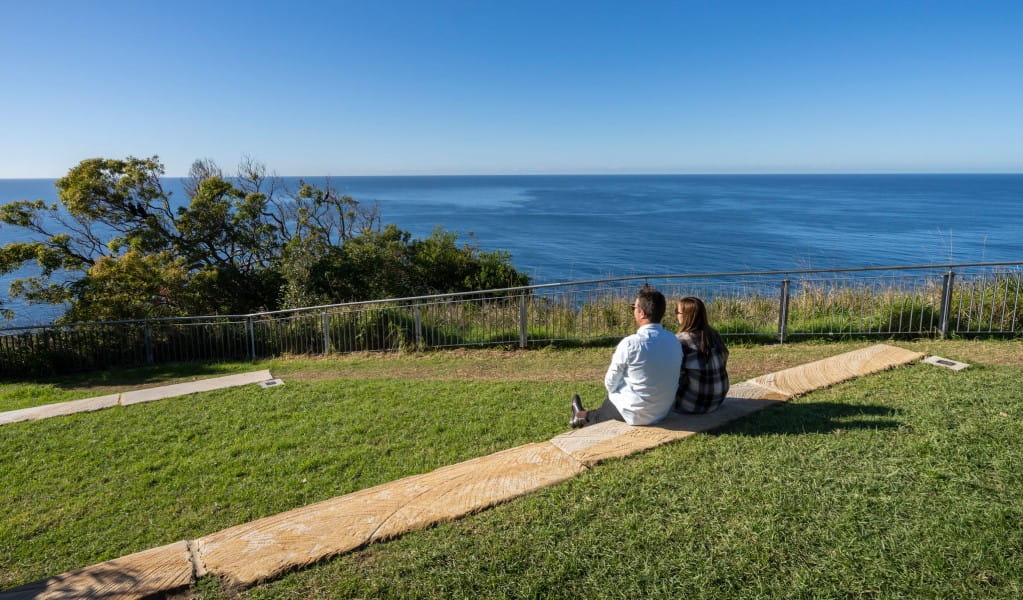 A couple enjoying the view at Crackneck Point lookout in Wyrrabalong National Park. Photo: John Spencer &copy; DPE