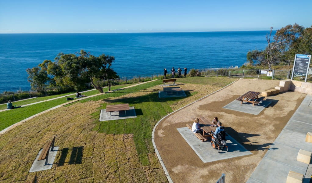 A low aerial view of Crackneck Point lookout with picnic tables and benches in Wyrrabalong National Park. Photo: John Spencer &copy; DPE