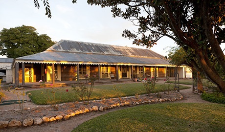 View of historic homestead with garden and pathways at twilight. Photo: David Finnegan &copy; DPIE