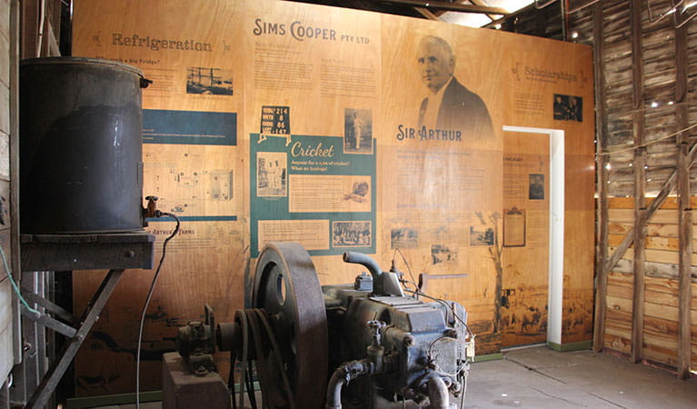 Historic refrigeration machinery with interpretation panels inside a wood shed. Photo: Simone Carmichael &copy; DPIE