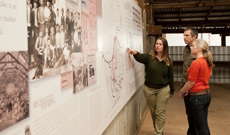 Ranger showing visitors a display in Yanga Woolshed. Photo: Rob Blackburn. 