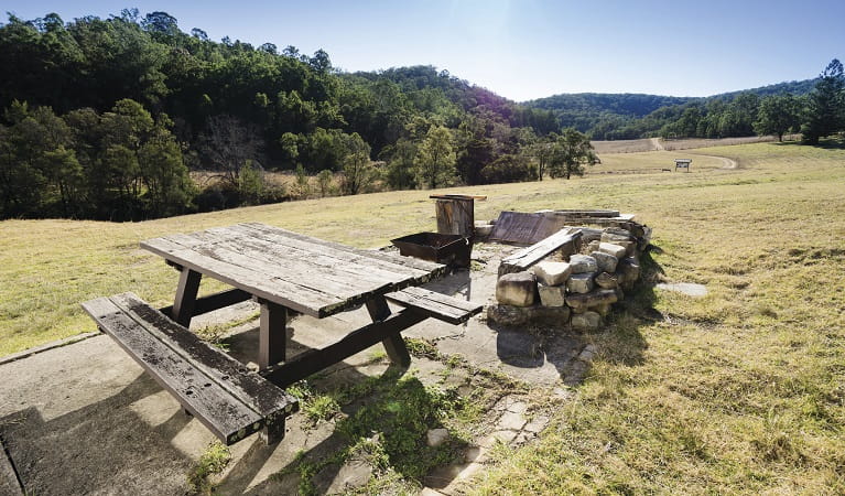 Fire pit and picnic table outside Big Yango House, Yengo National Park. Photo: Simone Cottrell/OEH