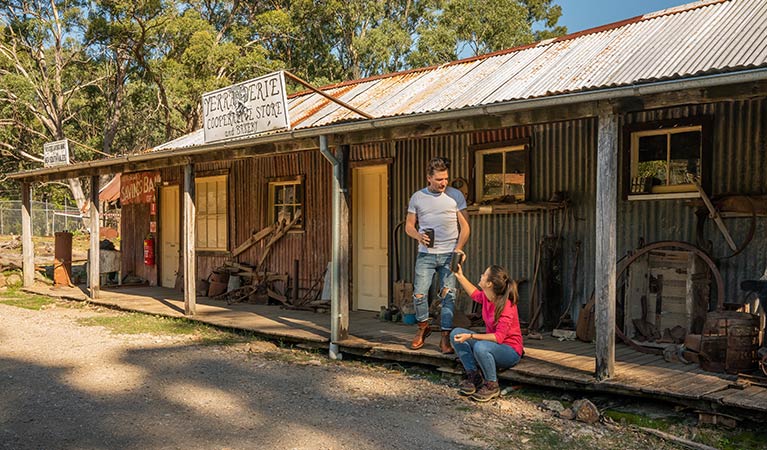 A couple drinking coffee on the verandah of The Bank Room in Yerranderie Private Town, Yerranderie Regional Park. Photo: John Spencer/OEH