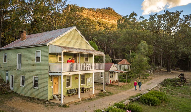 Friends strolling past Post Office Lodge in Yerranderie Private Town, Yerranderie Regional Park. Photo: John Spencer/OEH