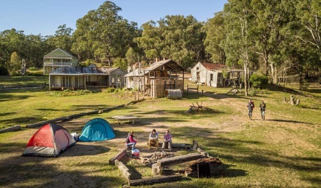 Campers sitting around the fire pit near their tents at Private Town campground in Yerranderie Regional Park. Photo: John Spencer/OEH