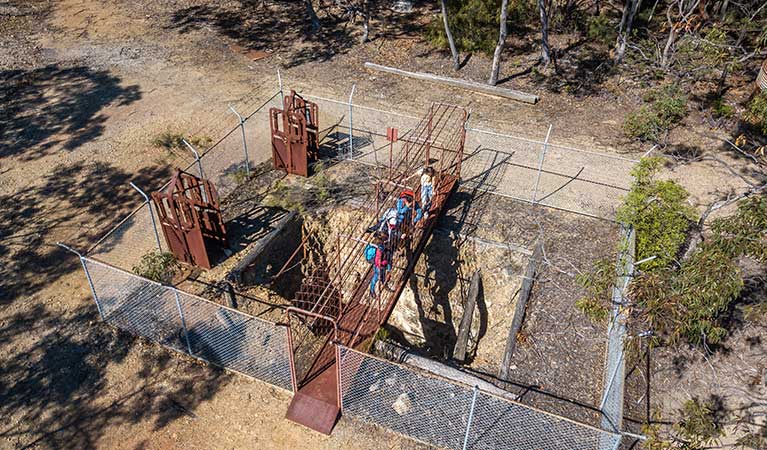 Arial view of people standing on a metal bridge over Silver Peak Mine, near Yerranderie Private Town in Yerranderie Regional Park. Photo: John Spencer/OEH