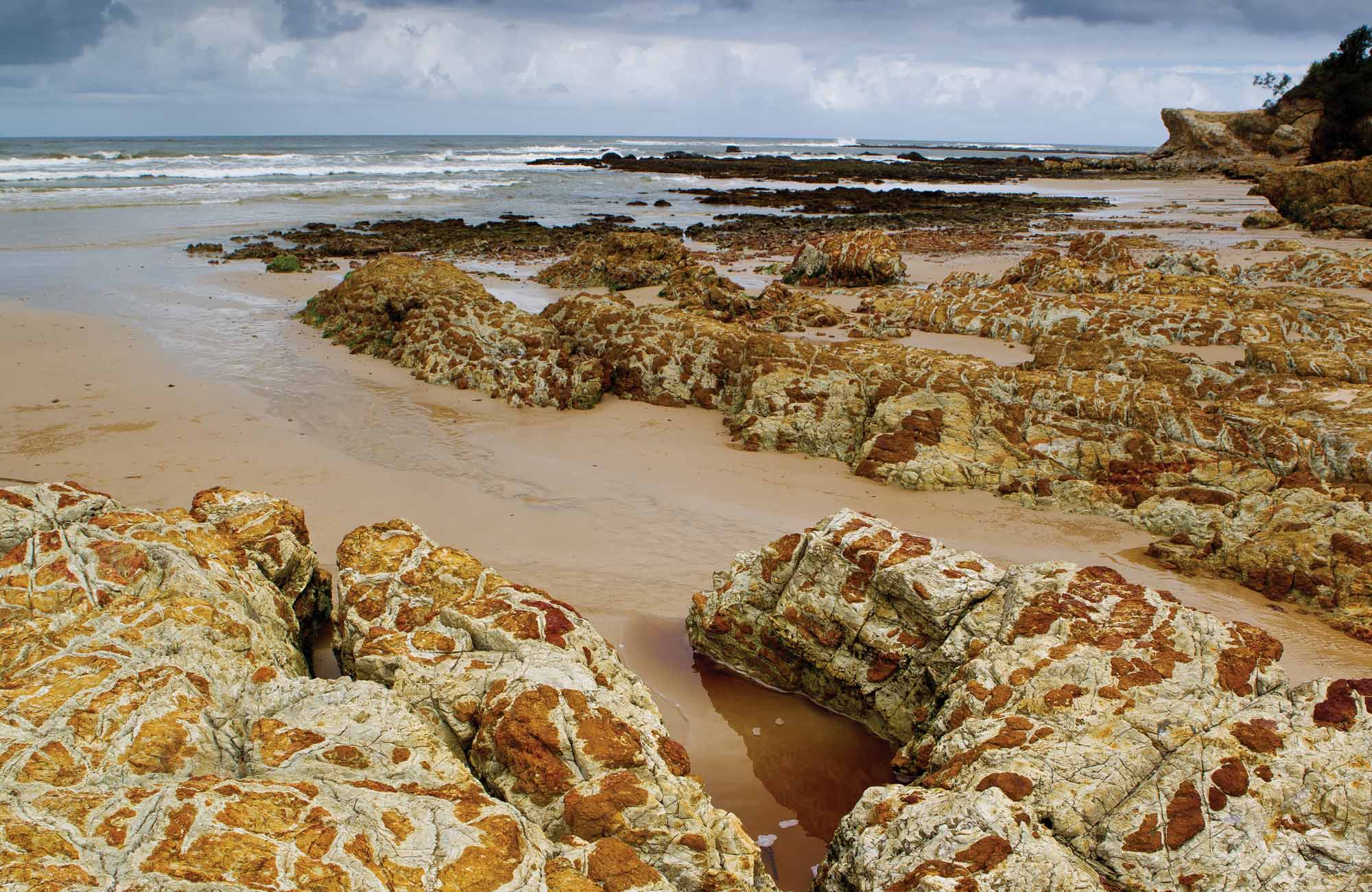 Golden sand and rocks in Yuraygir National Park. Photo: Rob Cleary