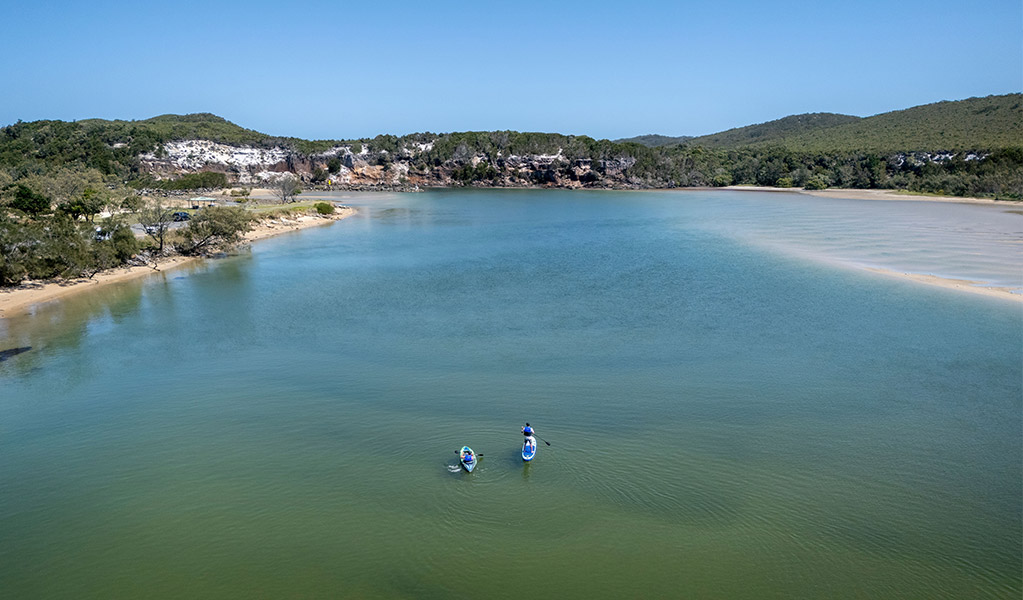Visitors kayaking and stand up paddle boarding on Wooli Wooli River. Credit: John Spencer &copy; DCCEEW