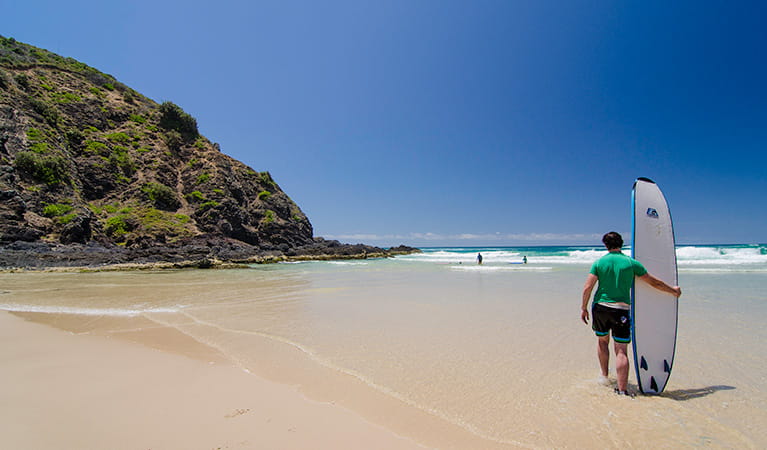 Surfer on the beach, Cape Byron State Conservation Area. Photo: John Spencer