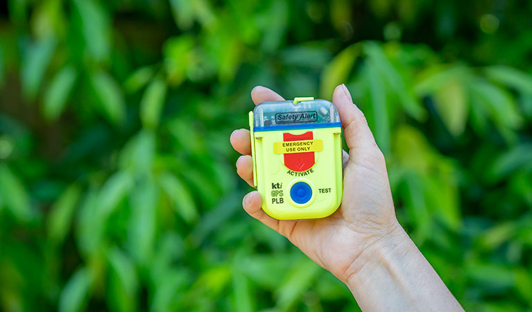 Person holding a personal locator beacon (PLB). Photo: John Spencer/DPIE