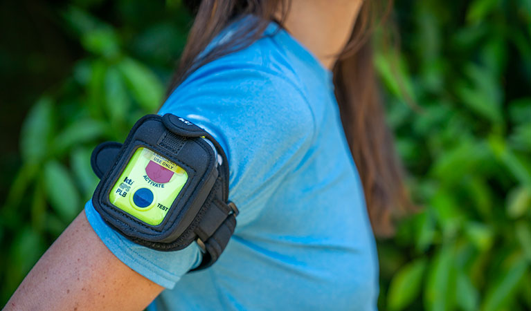 A walker with a personal locator beacon (PLB) strapped to their arm. Photo: John Spencer/DPIE