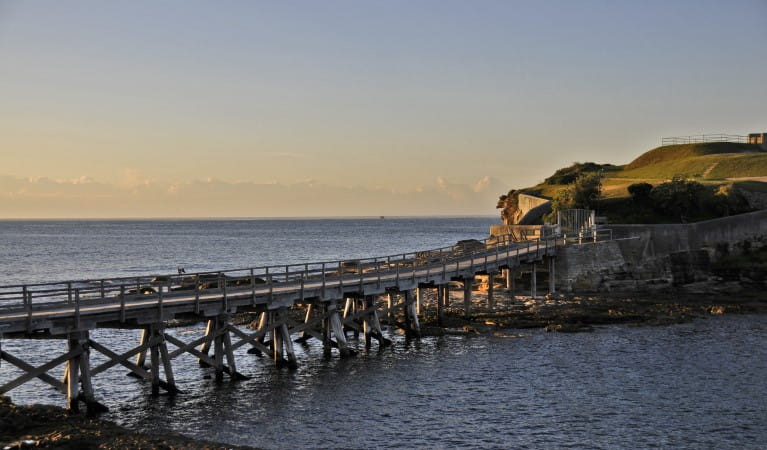 The wooden footbridge to Bare Island Fort at sunset in Kamay Botany Bay National Park. Photo: Kevin McGrath &copy; OEH