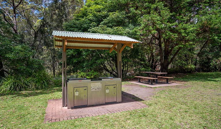 A covered barbecue with a picnic table in the background at Greenfield Beach picnic area in Jervis Bay National Park. Photo: John Spencer &copy; DPIE