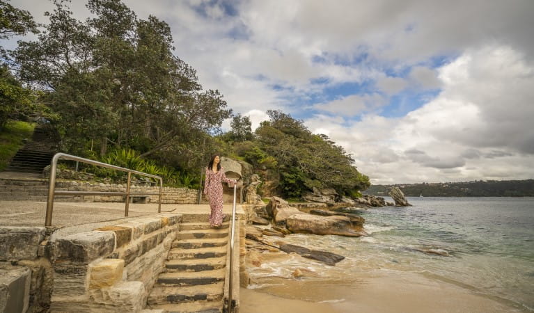 A woman walking down the steps to Shark Beach in Sydney Harbour National Park. Photo: John Spencer &copy; OEH