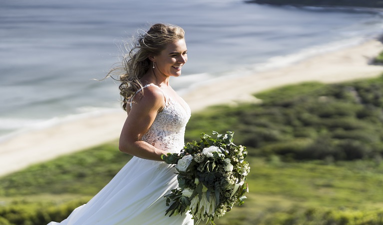 Bride celebrating her wedding at Hickson Street lookout. Photo: Michael Delore &copy; Michael Delore