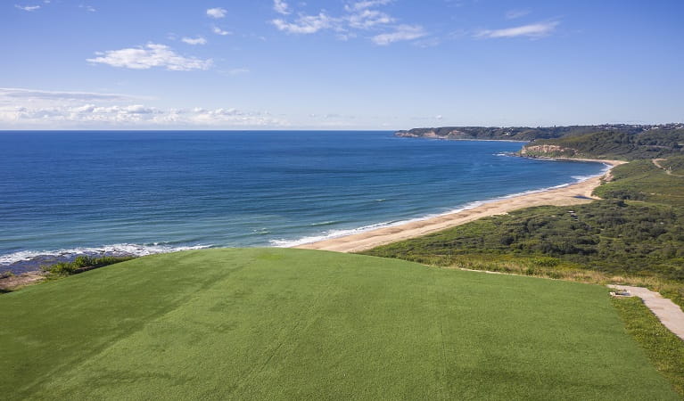 View of the lawn at Hickson Street lookout, with beach,  bushland and ocean in the background.  Photo credit: John Spencer &copy; DPIE  
