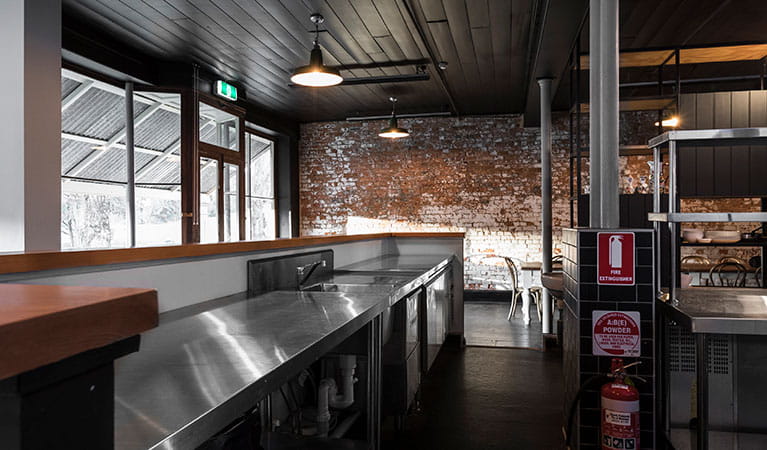 The benchtop in the commercial kitchen with a view towards the windows and tables at Hosies. Photo:  Jennifer Leahy &copy; DPE