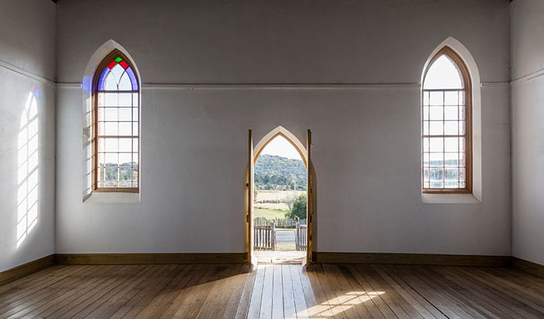 Interior arch stained glass windows and arch doorway at Sacred Heart Church in Hill End Historic Site. Photo: Jennifer Leahy &copy; DPE