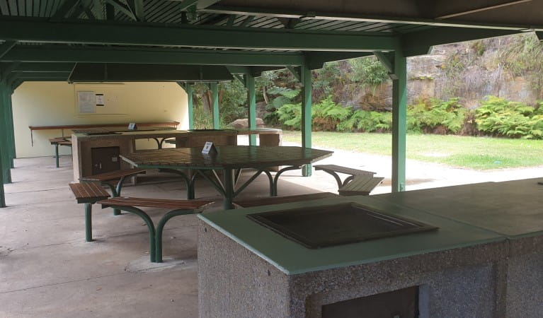 Picnic tables and a barbecue at The Station picnic shelter in Ku-ring-gai Chase National Park. Photo: Nicole Ribera &copy; OEH