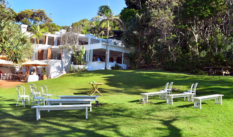 Chairs and benches set up on Wategos lawn for a wedding ceremony in Cape Byron State Conservation Area. Photo: Fiora Sacco &copy; DPIE