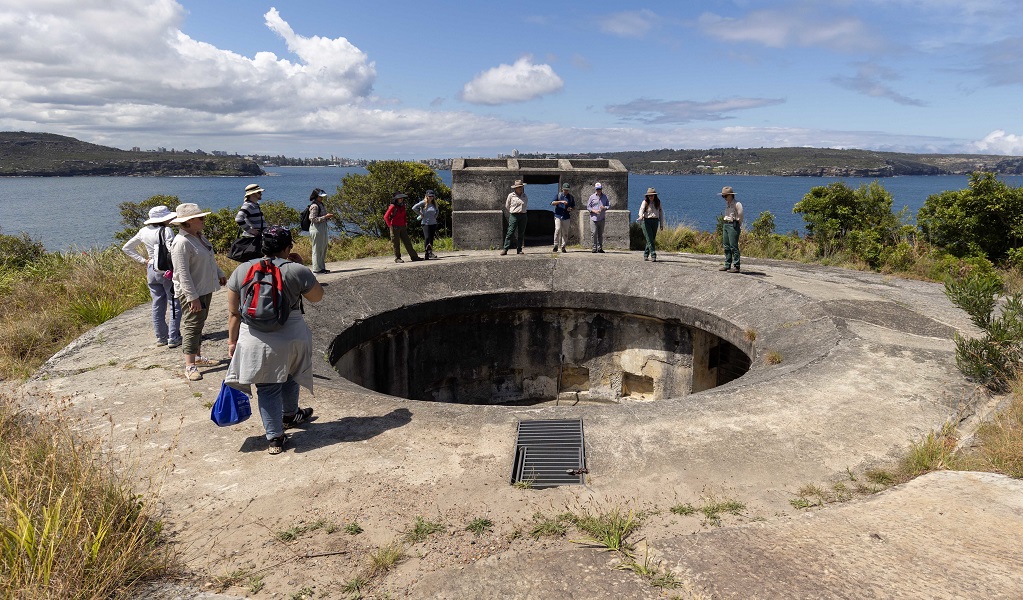 Volunteers pause around one of Middle Head's historic military fortifications, during a guided tour, Sydney Harbour National Park. Credit: Peter Taseski/DCCEEW &copy; DCCEEW